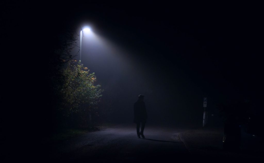 a person walking in the dark